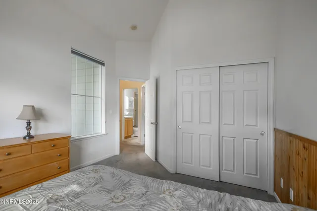 a bedroom with a bed and a dresser in it