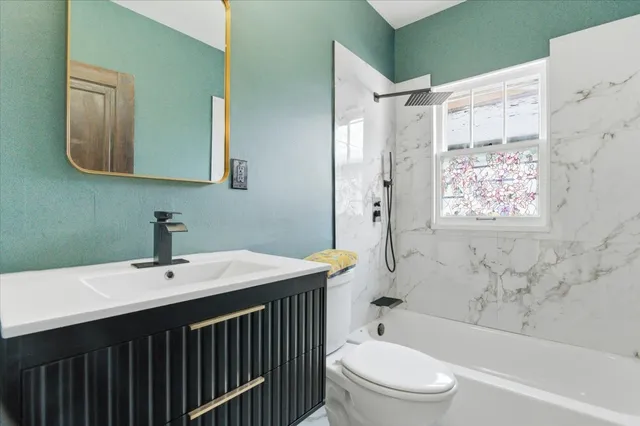 a bathroom with a sink toilet and shower