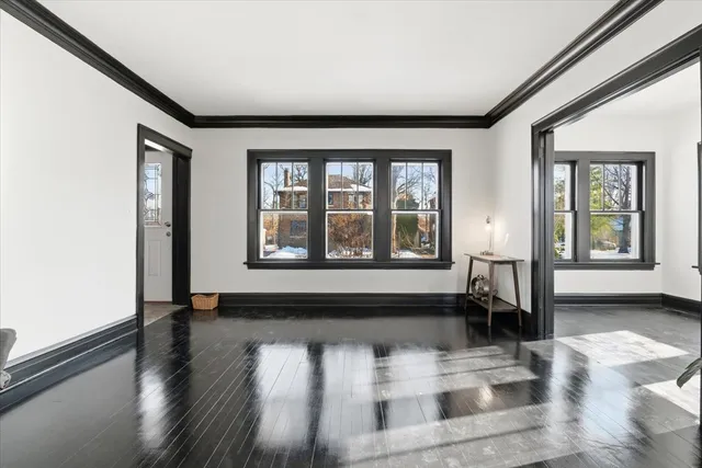 a view of a room with wooden floor and windows