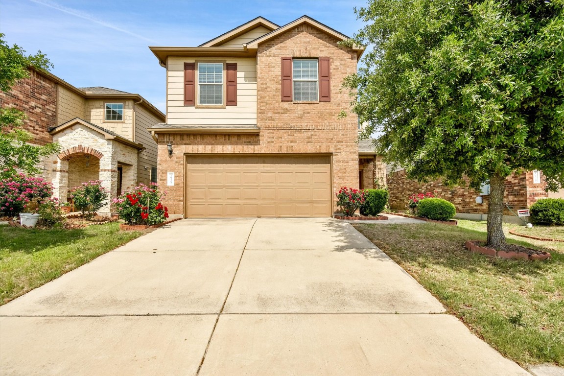 a front view of a house with a yard and garage