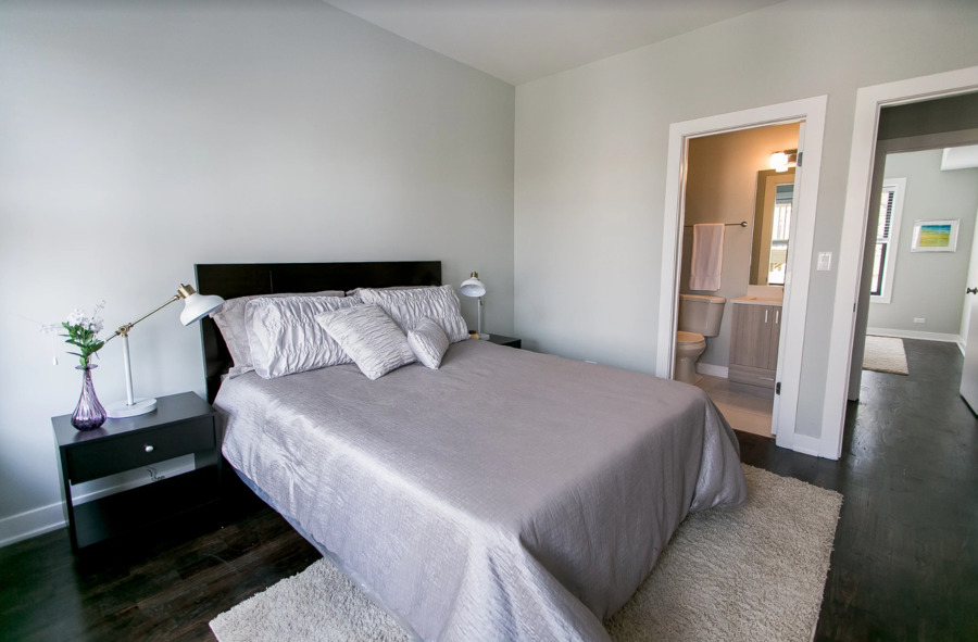 Undisclosed Address Chicago, IL 60613 - Photo 4 of 4 a bedroom with a bed and wooden floor