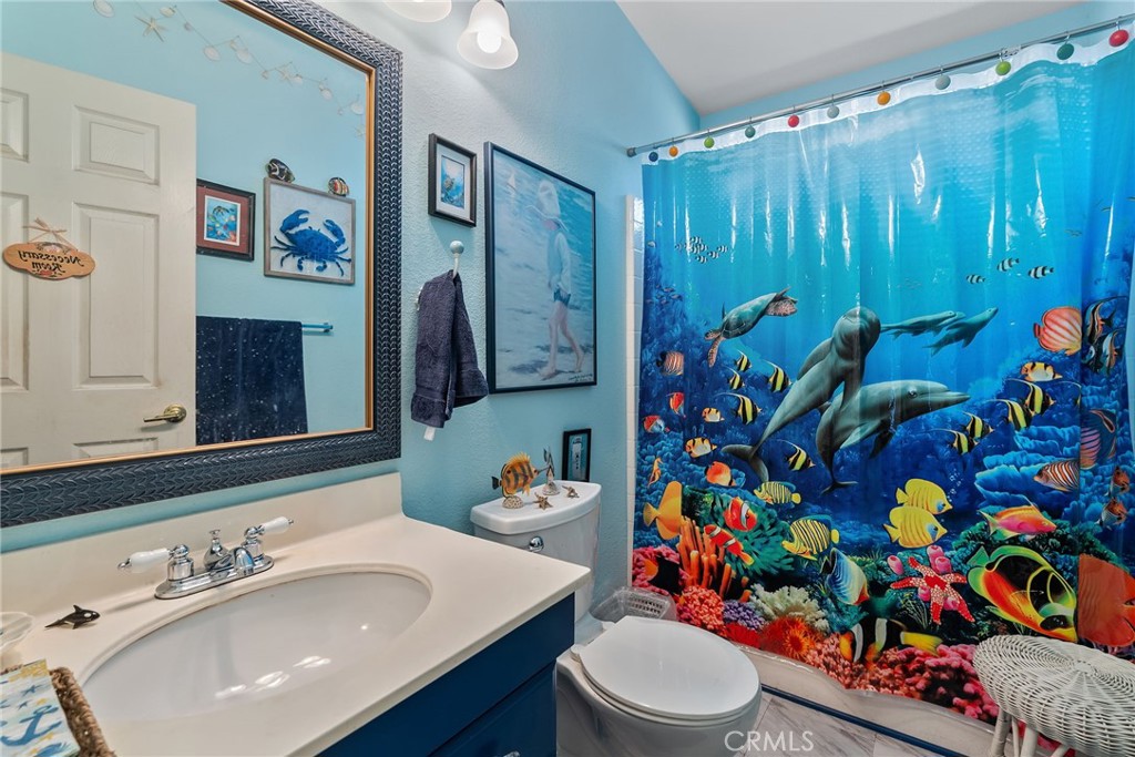 7271 Katella Avenue, Unit 101 Stanton, CA 90680 - Photo 20 of 34 a bathroom with a sink mirror and toilet