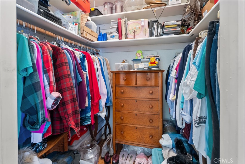 7271 Katella Avenue, Unit 101 Stanton, CA 90680 - Photo 30 of 34 a view of walk in closet with clothes and shoes