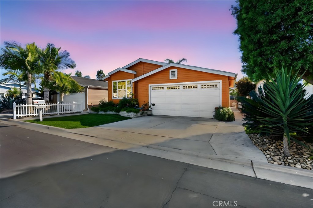 7271 Katella Avenue, Unit 101 Stanton, CA 90680 - Photo 34 of 34 a front view of a house with a yard and garage