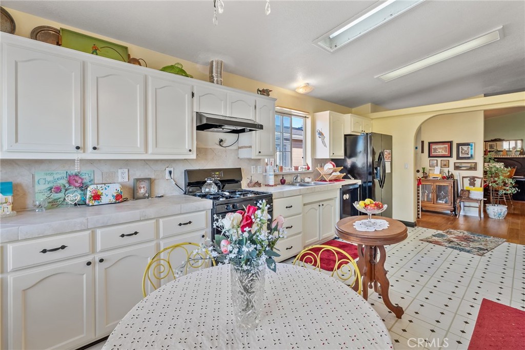 7271 Katella Avenue, Unit 101 Stanton, CA 90680 - Photo 9 of 34 a open kitchen with stainless steel appliances granite countertop a sink dishwasher and cabinets with wooden floor