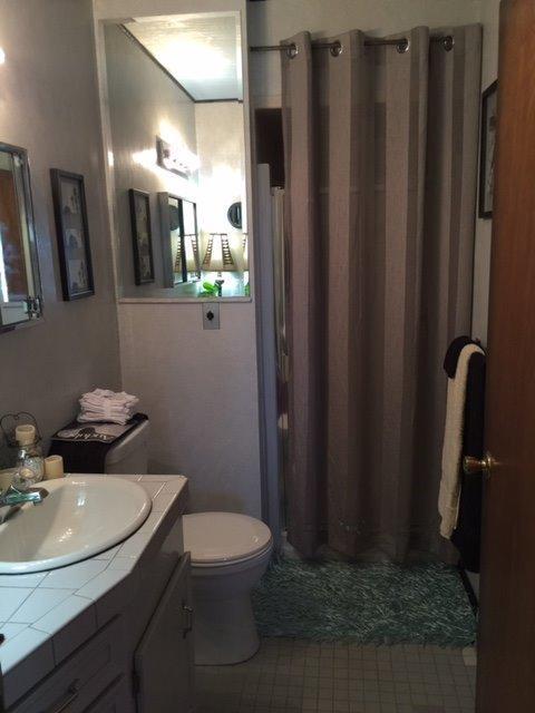 502 West Hilltop Road Talent, OR 97540 - Photo 22 of 34 a bathroom with sink a mirror a toilet and vanity