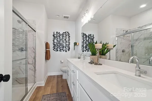 a bathroom with a double vanity sink and a mirror