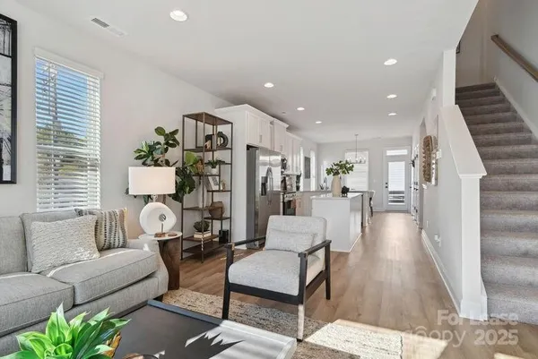 a living room with furniture and wooden floor