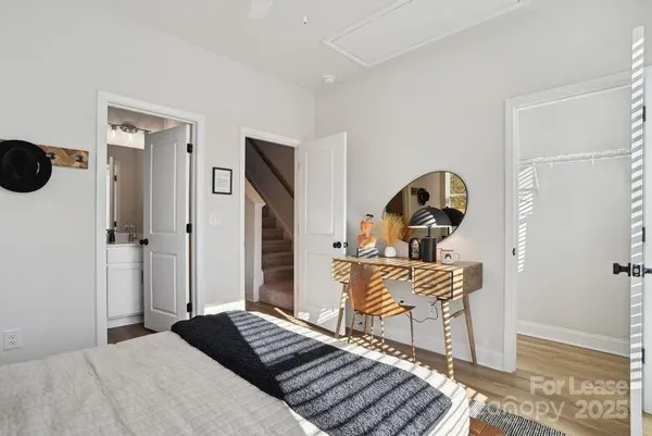 a bedroom with a bed and wooden floor