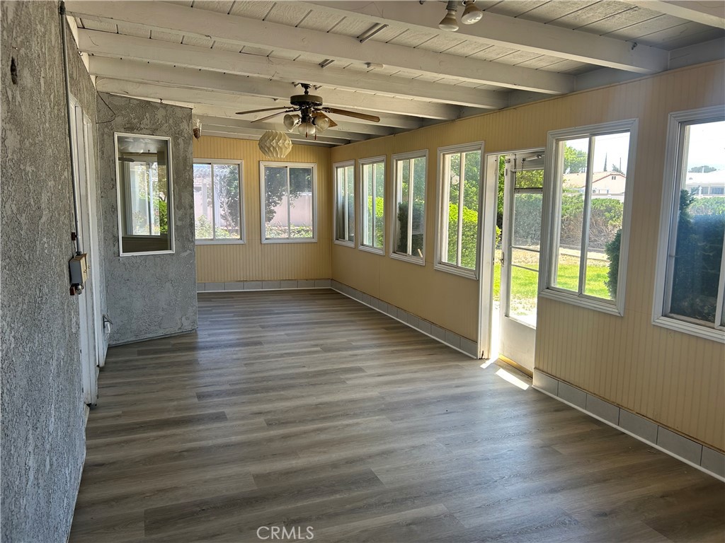 20187 Itasca Road Apple Valley, CA 92308 - Photo 26 of 35 a view of an empty room with wooden floor and a window