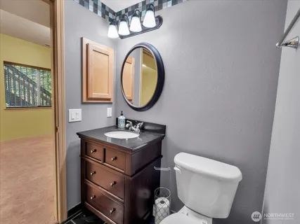 a bathroom with a toilet a sink and a mirror