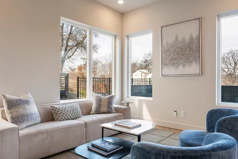 a bedroom with a bed and a large window