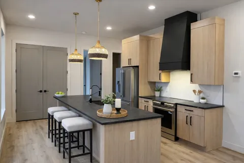 a kitchen with sink and refrigerator