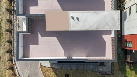 aerial view of a house with a yard and potted plants