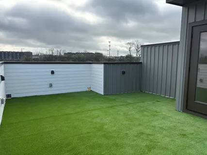 a view of a house with pool and trees in the background