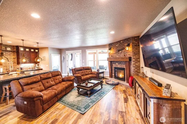 a living room with furniture a fireplace and a flat screen tv