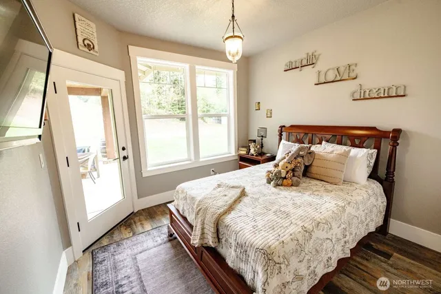 a bed sitting in a bedroom next to a window