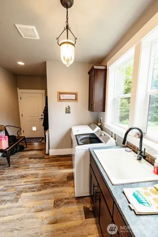 a kitchen with stainless steel appliances granite countertop a sink a stove and a refrigerator