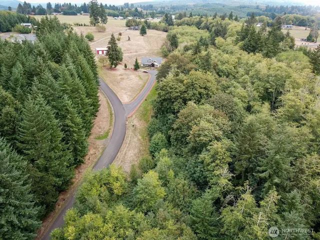 an aerial view of a house with outdoor space and lake view