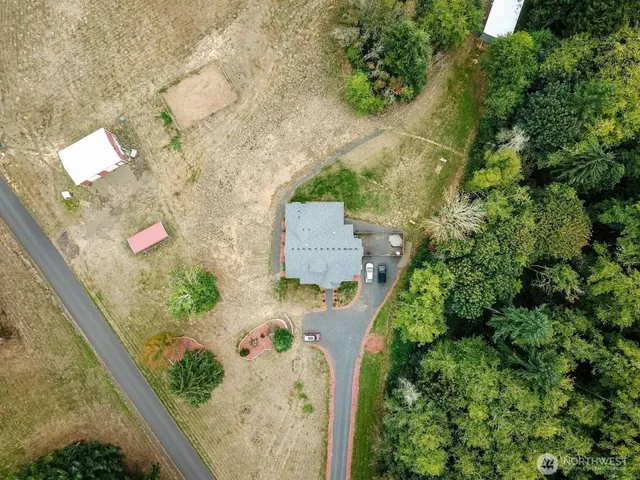 an aerial view of a house with a yard