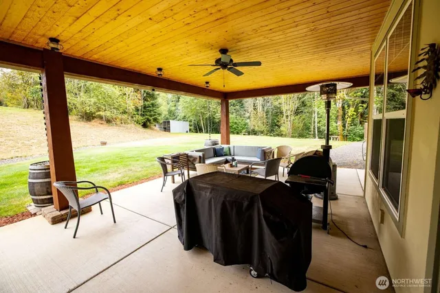 a view of a patio with lawn chairs under an umbrella