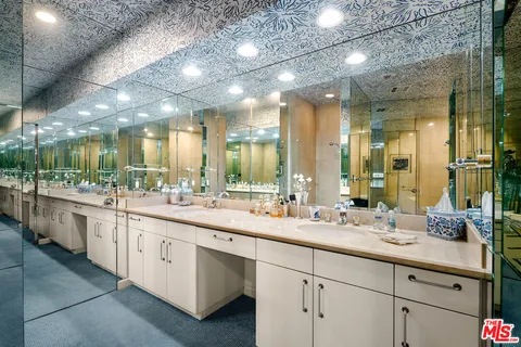 a bathroom with a double vanity sink and a mirror