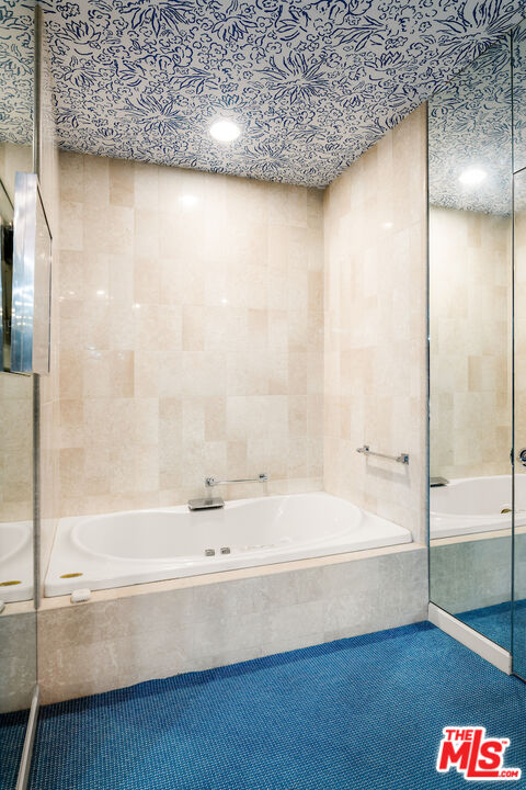 10580 Wilshire Boulevard, Unit 45 Los Angeles, CA 90024 - Photo 25 of 35 a bathroom with a bathtub and a shower