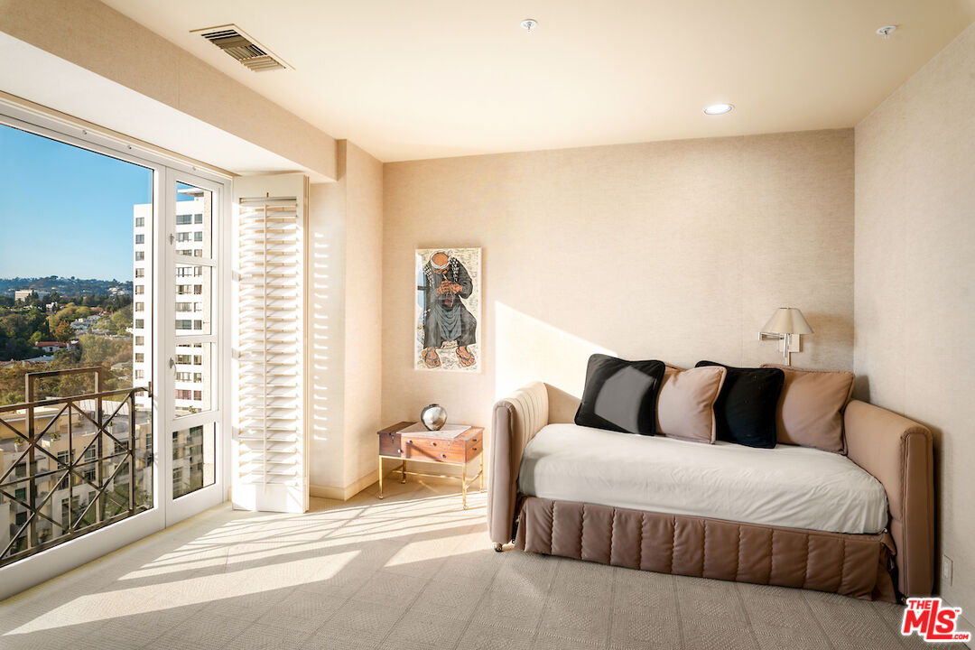 10580 Wilshire Boulevard, Unit 45 Los Angeles, CA 90024 - Photo 29 of 35 a bedroom with a bed and a large window