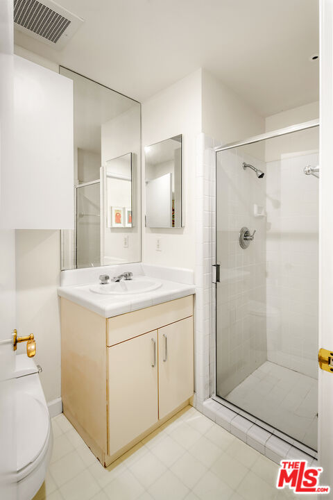 10580 Wilshire Boulevard, Unit 45 Los Angeles, CA 90024 - Photo 34 of 35 a bathroom with a sink a toilet and shower