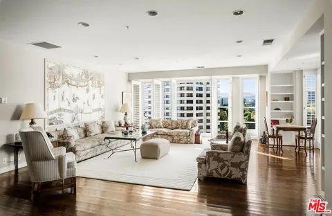 a living room with fireplace furniture and wooden floor