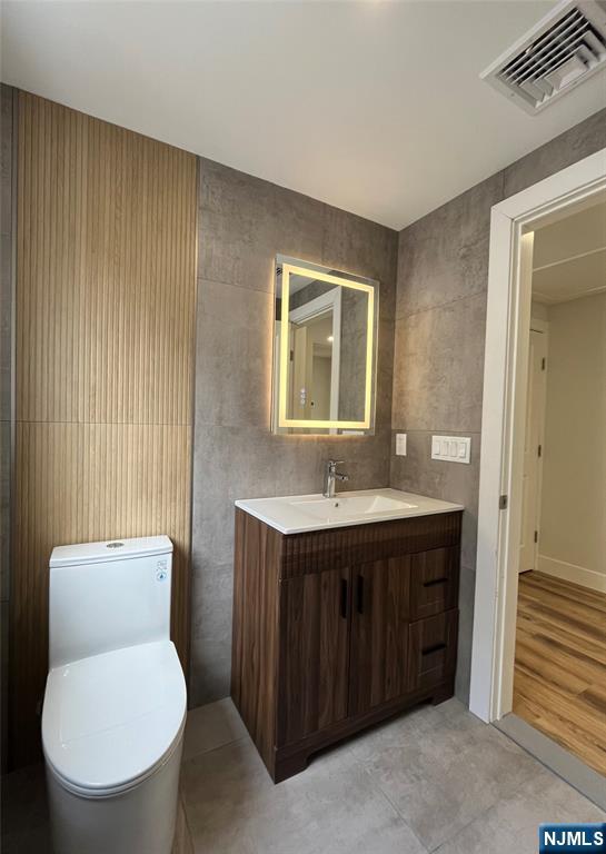 17 Market Street, Unit 2 Garfield, NJ 07026 - Photo 12 of 16 a bathroom with a toilet sink and mirror