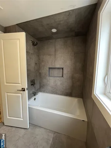 a white bath tub sitting next to a window
