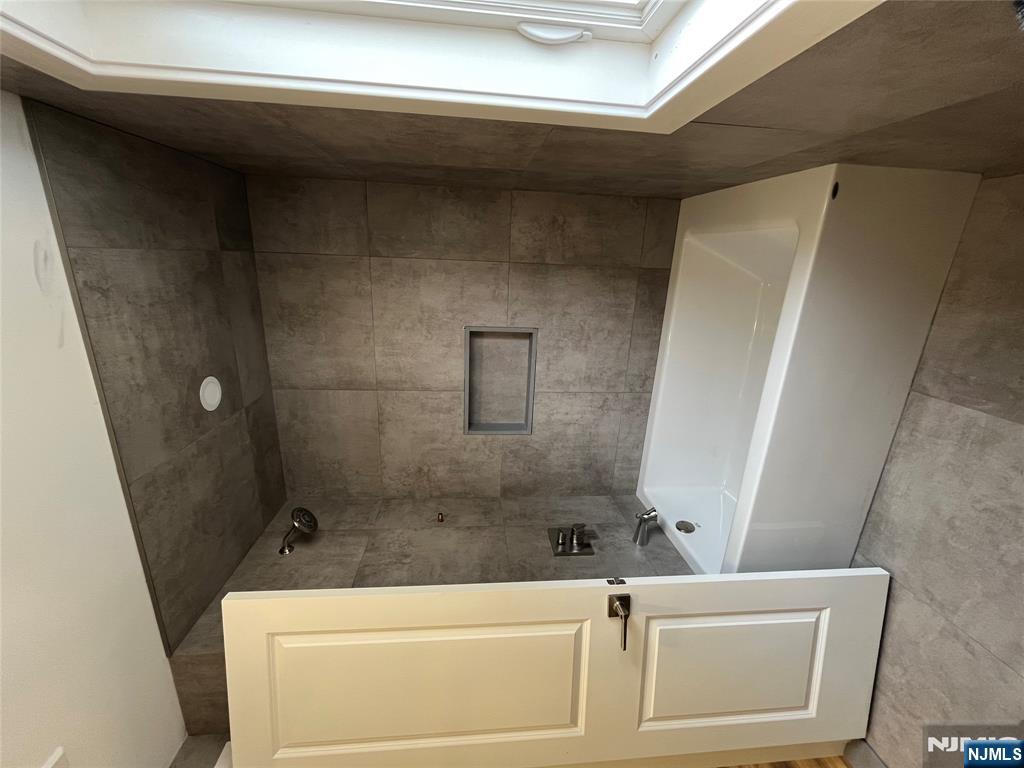 17 Market Street, Unit 2 Garfield, NJ 07026 - Photo 13 of 16 a white bath tub sitting next to a window