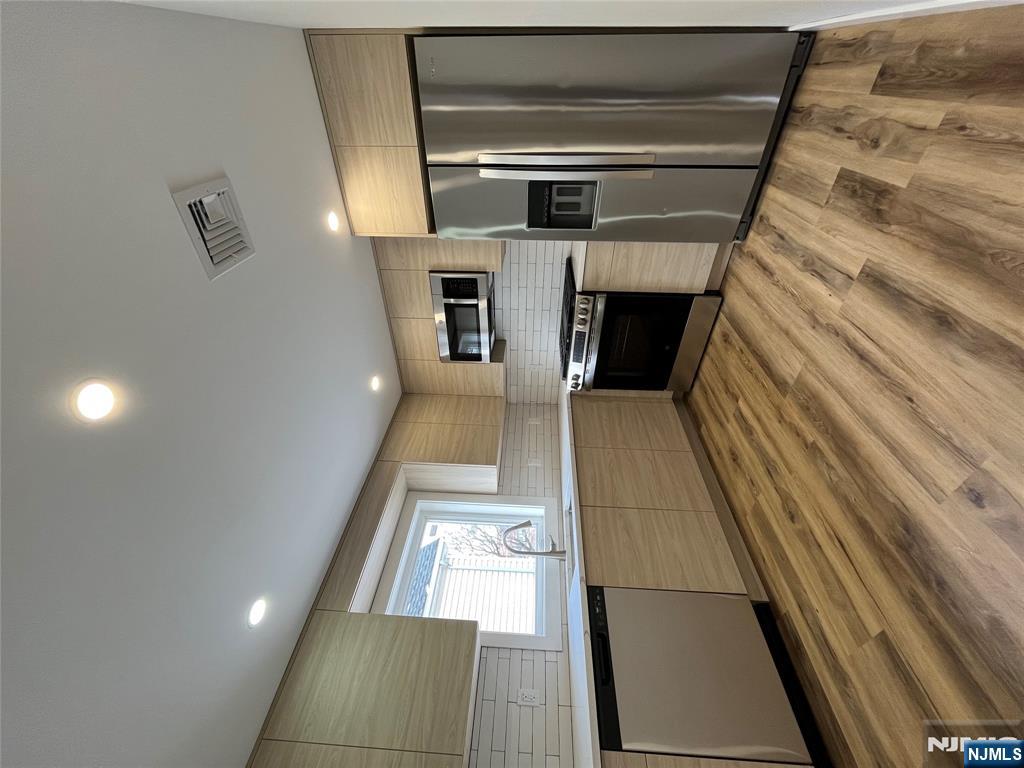 17 Market Street, Unit 2 Garfield, NJ 07026 - Photo 14 of 16 a large kitchen with granite countertop a refrigerator and a stove top oven