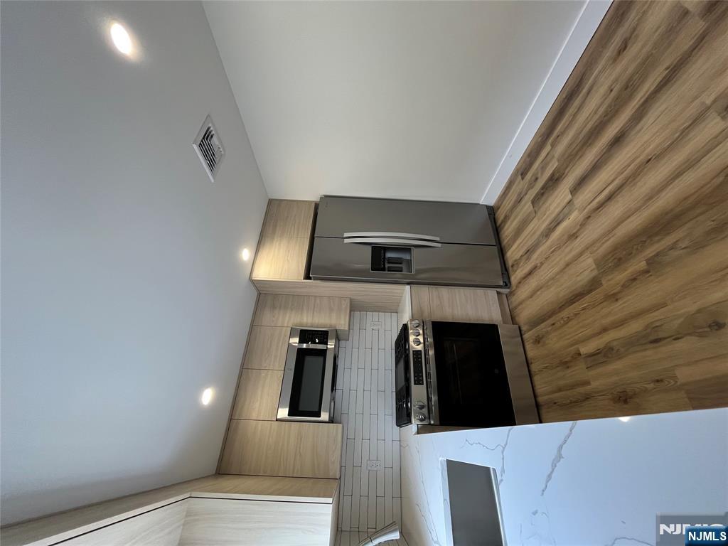 17 Market Street, Unit 2 Garfield, NJ 07026 - Photo 16 of 16 a kitchen with granite countertop a refrigerator and a stove top oven