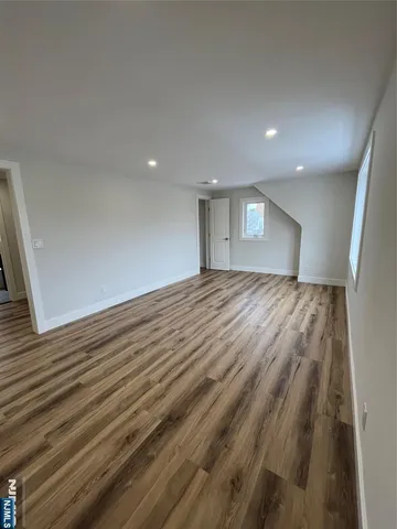 a view of an empty room and wooden floor