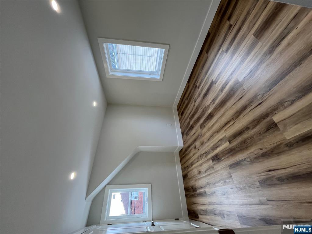 17 Market Street, Unit 2 Garfield, NJ 07026 - Photo 5 of 16 an empty room with wooden floor and windows