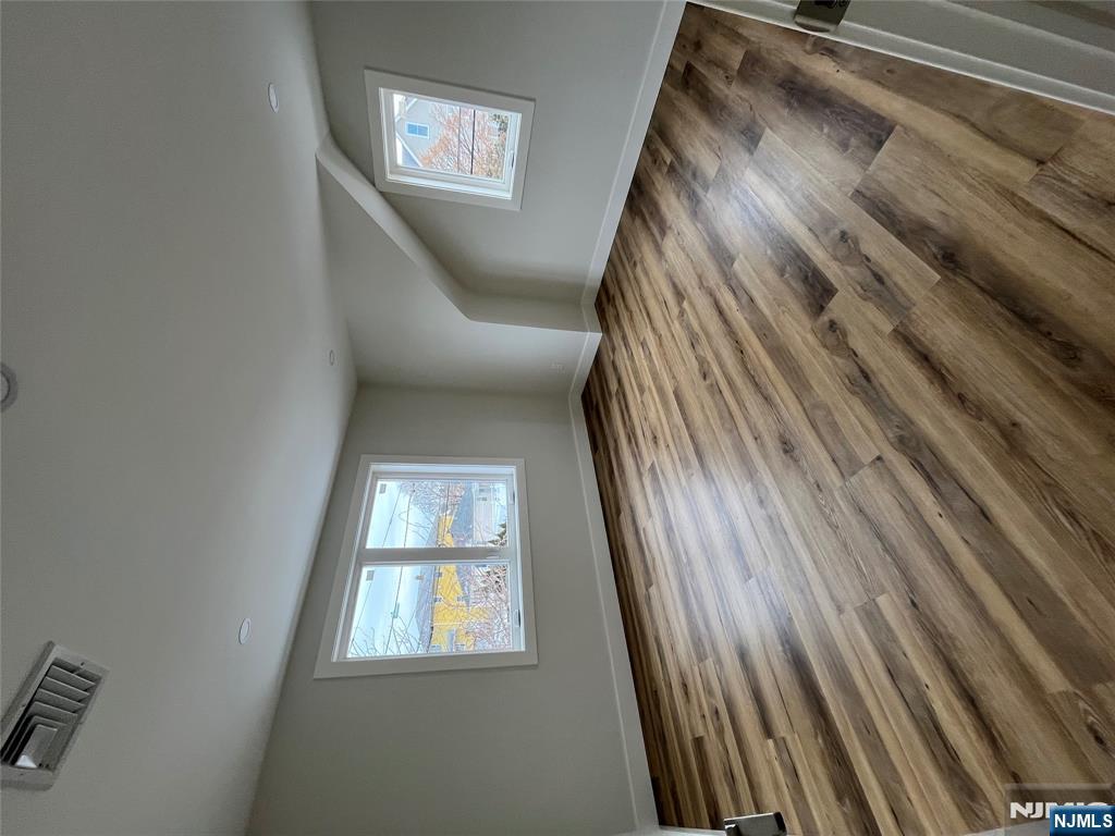 17 Market Street, Unit 2 Garfield, NJ 07026 - Photo 8 of 16 an empty room with wooden floor and windows