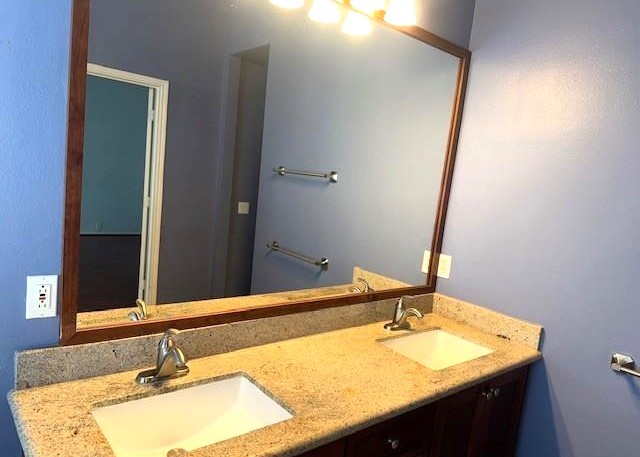 11014 Redhaven Court Houston, TX 77065 - Photo 13 of 20 a bathroom with a granite countertop sink and a mirror