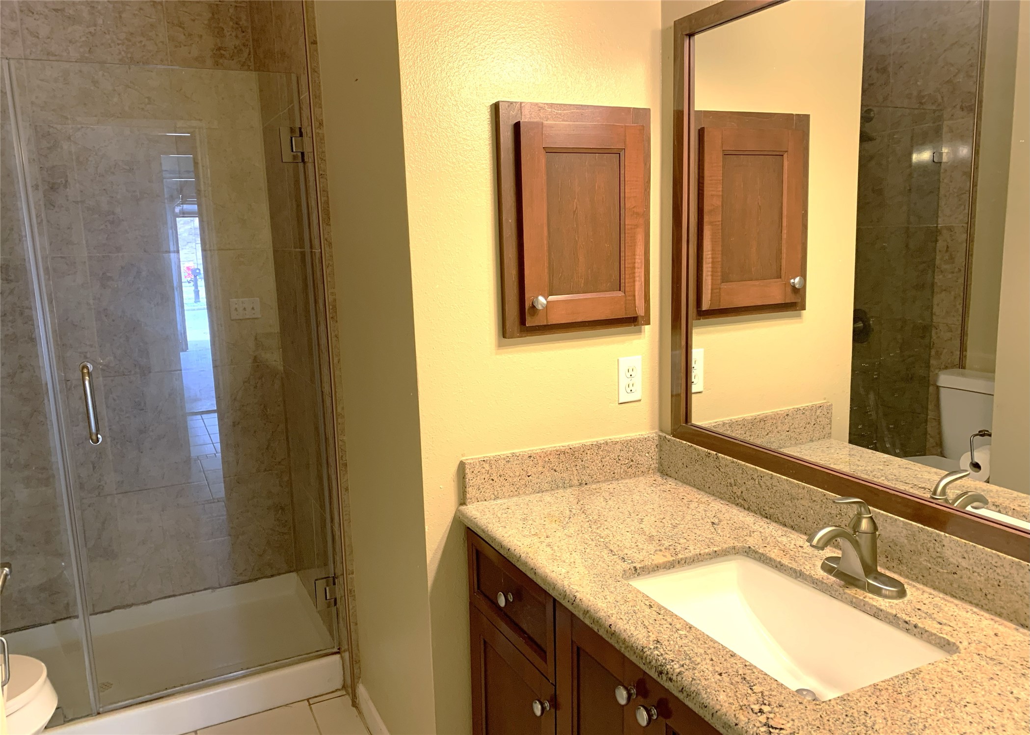 11014 Redhaven Court Houston, TX 77065 - Photo 19 of 20 a bathroom with a granite countertop sink and a mirror
