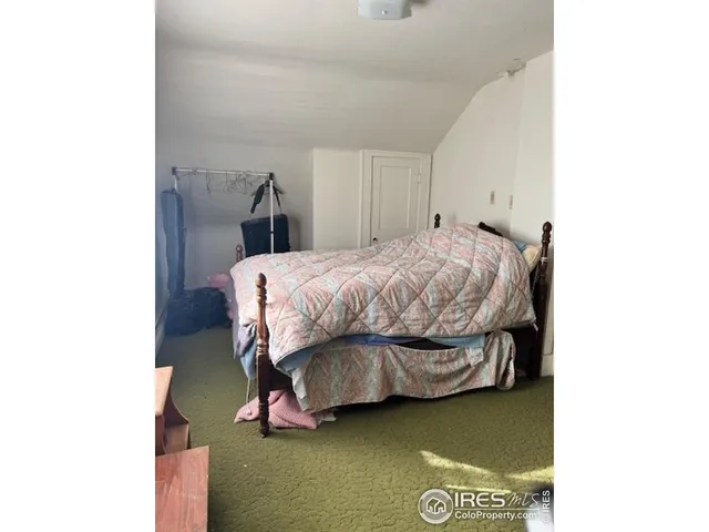 a bedroom with a bed and mirror