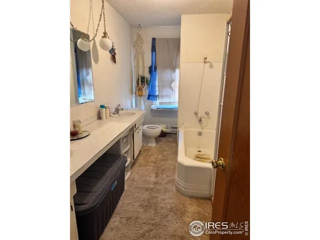 a bathroom with a double vanity sink toilet and shower