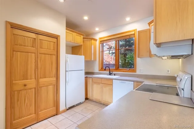 a kitchen with refrigerator cabinets and wooden floor