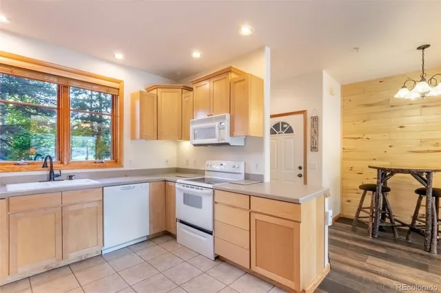 a kitchen with stainless steel appliances granite countertop a sink and cabinets