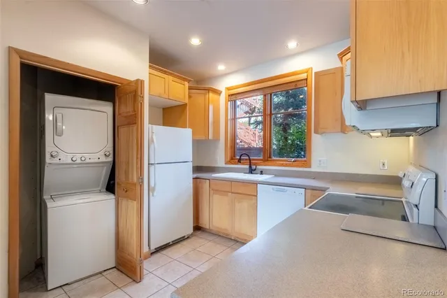 a kitchen with a refrigerator and sink