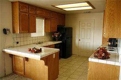17136 La Canada Road Madera, CA 93636 - Photo 6 of 14 Beautiful kitchen is close enough to the action to see what is going on. The laundry room is conveniently located through the door in the rear of kitchen. Laundry room access is also available through the hallway. Access to backyard and patio is available through the laundry room as well as through the living room.