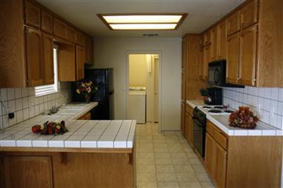 17136 La Canada Road Madera, CA 93636 - Photo 7 of 14 Looking through kitchen into the laundry room. The dryer has gas and electrical hook ups in place.