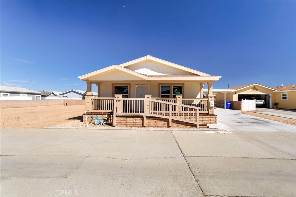 22241 Nisqually Road, Unit 103 Apple Valley, CA 92308 - Photo 3 of 34 Front exterior with covered porch, ramp and large driveway.