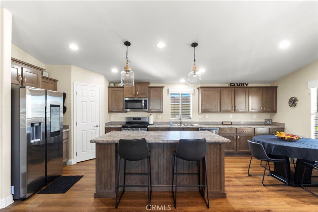 22241 Nisqually Road, Unit 103 Apple Valley, CA 92308 - Photo 7 of 34 Kitchen with large island, stainless steel appliances, and ample storage
