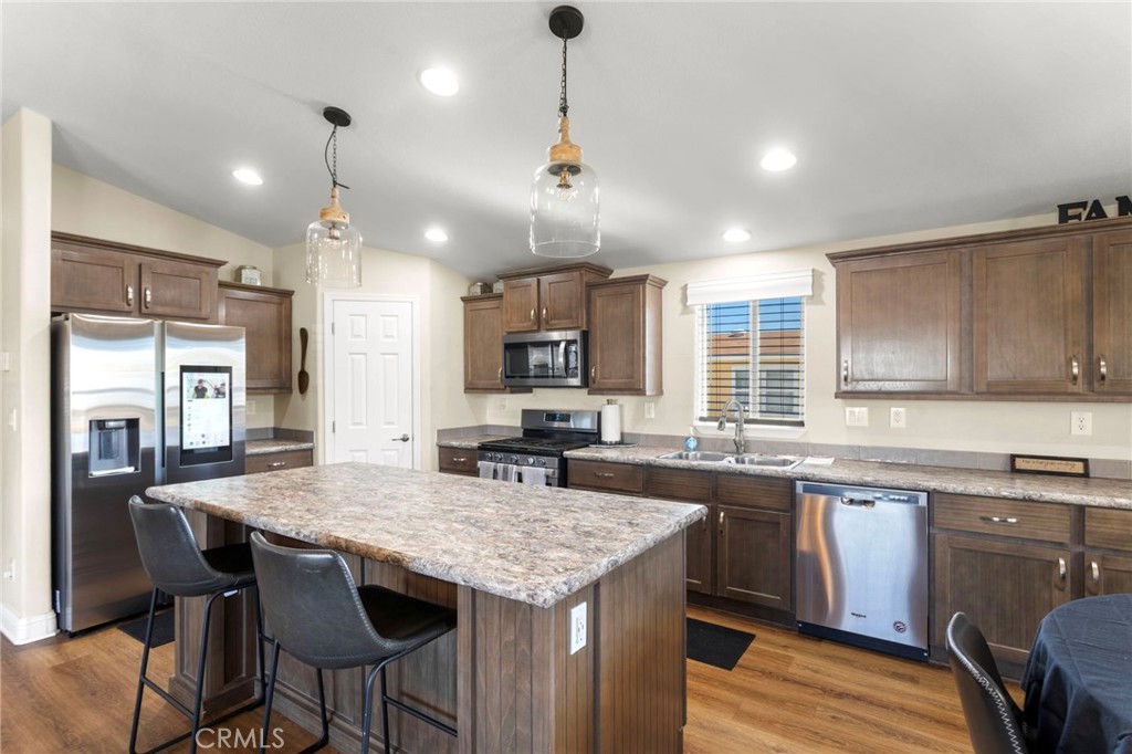 22241 Nisqually Road, Unit 103 Apple Valley, CA 92308 - Photo 9 of 34 Bright kitchen with island, cabinetry, and modern finishes